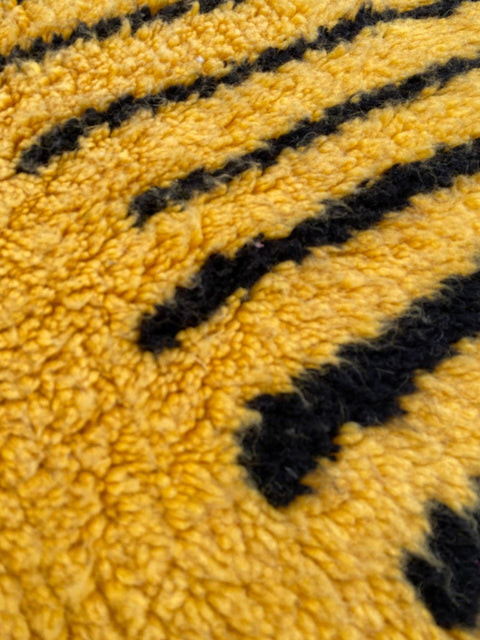 Close-up detail of the fuzzy texture and contrasting lines on the rug.