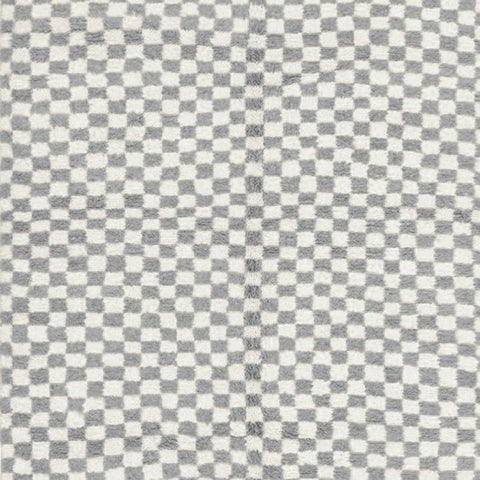 Close-up detail of the gray checkered Moroccan rug's texture on a white background.