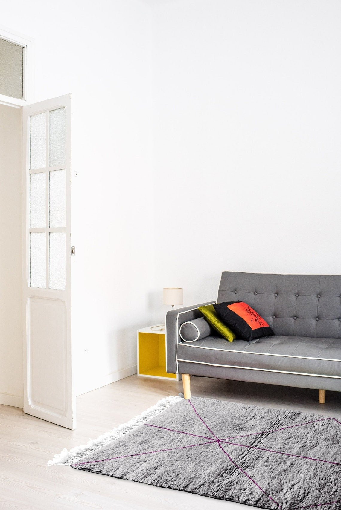 Lifestyle shot of the gray Moroccan Berber rug with a geometric design in a natural setting.