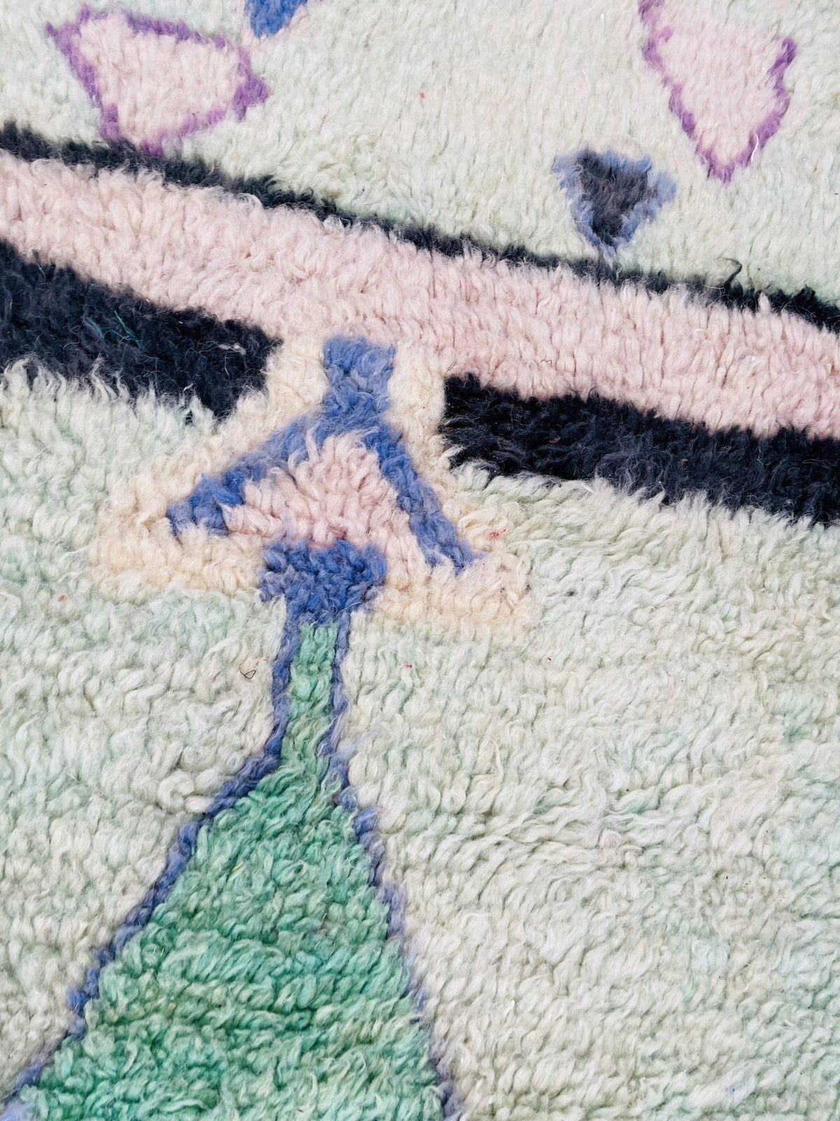 Detail shot of the vintage Boujaad Moroccan rug showcasing its colorful tribal patterns.