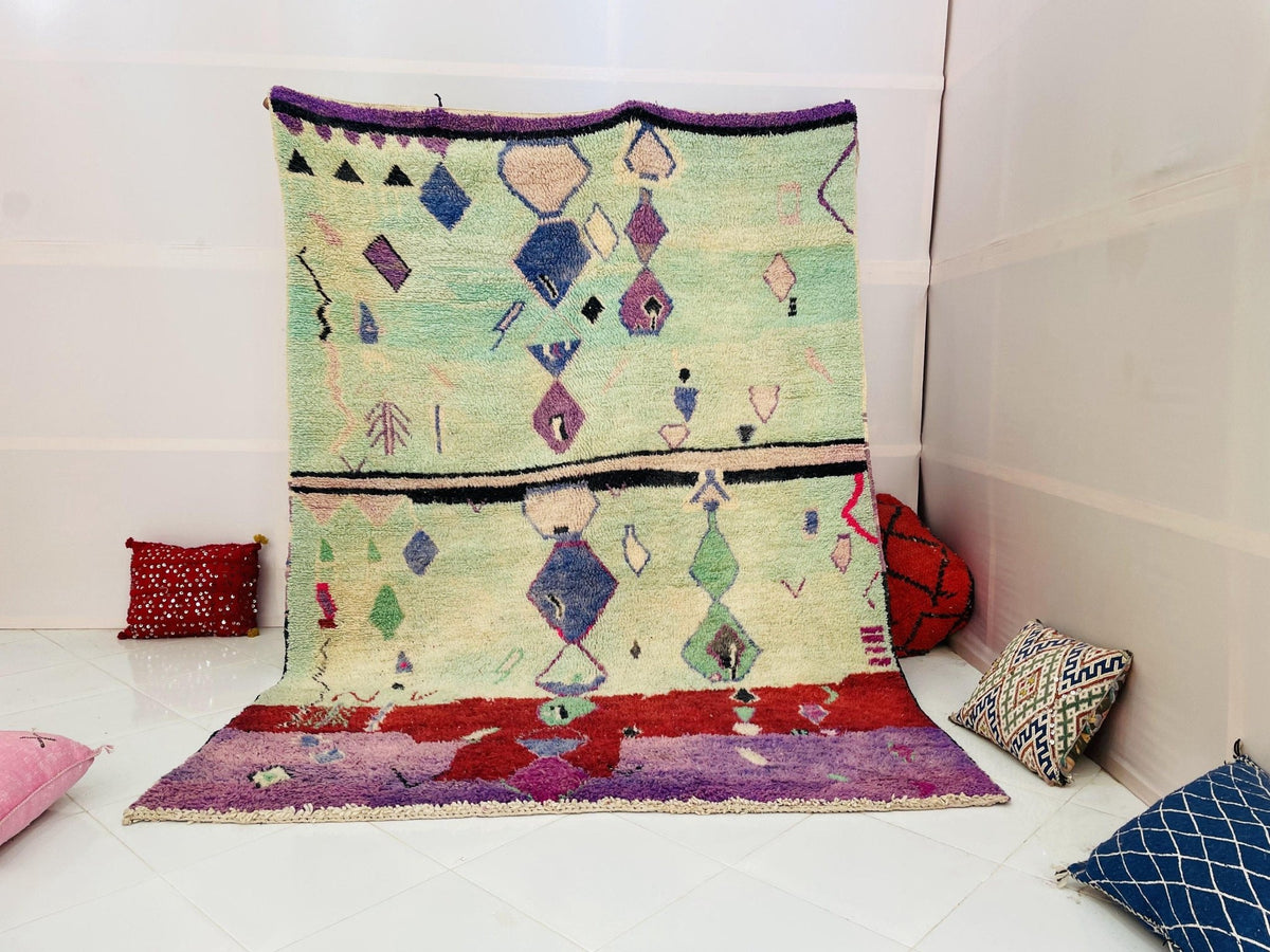 Lifestyle view of the green and purple geometric Boujaad Moroccan rug with tribal patterns.