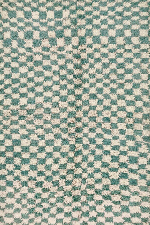 Close-up detail of the green checkered Moroccan tribal rug featuring its intricate design.