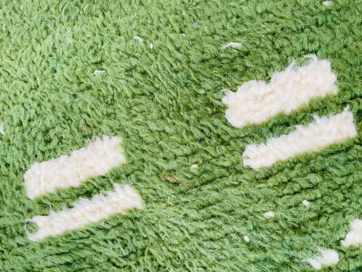 Detail close-up of a green vintage Moroccan rug with a vintage design.