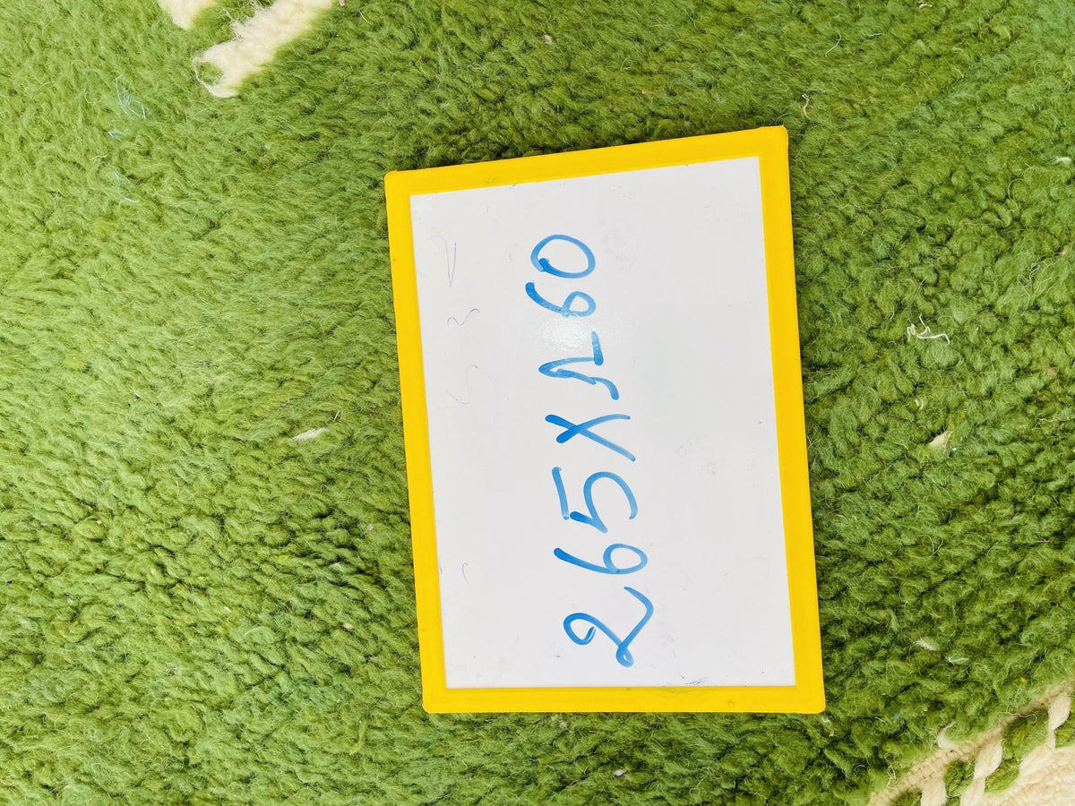 Detail shot of a price tag on a green and pink vintage Moroccan rug.