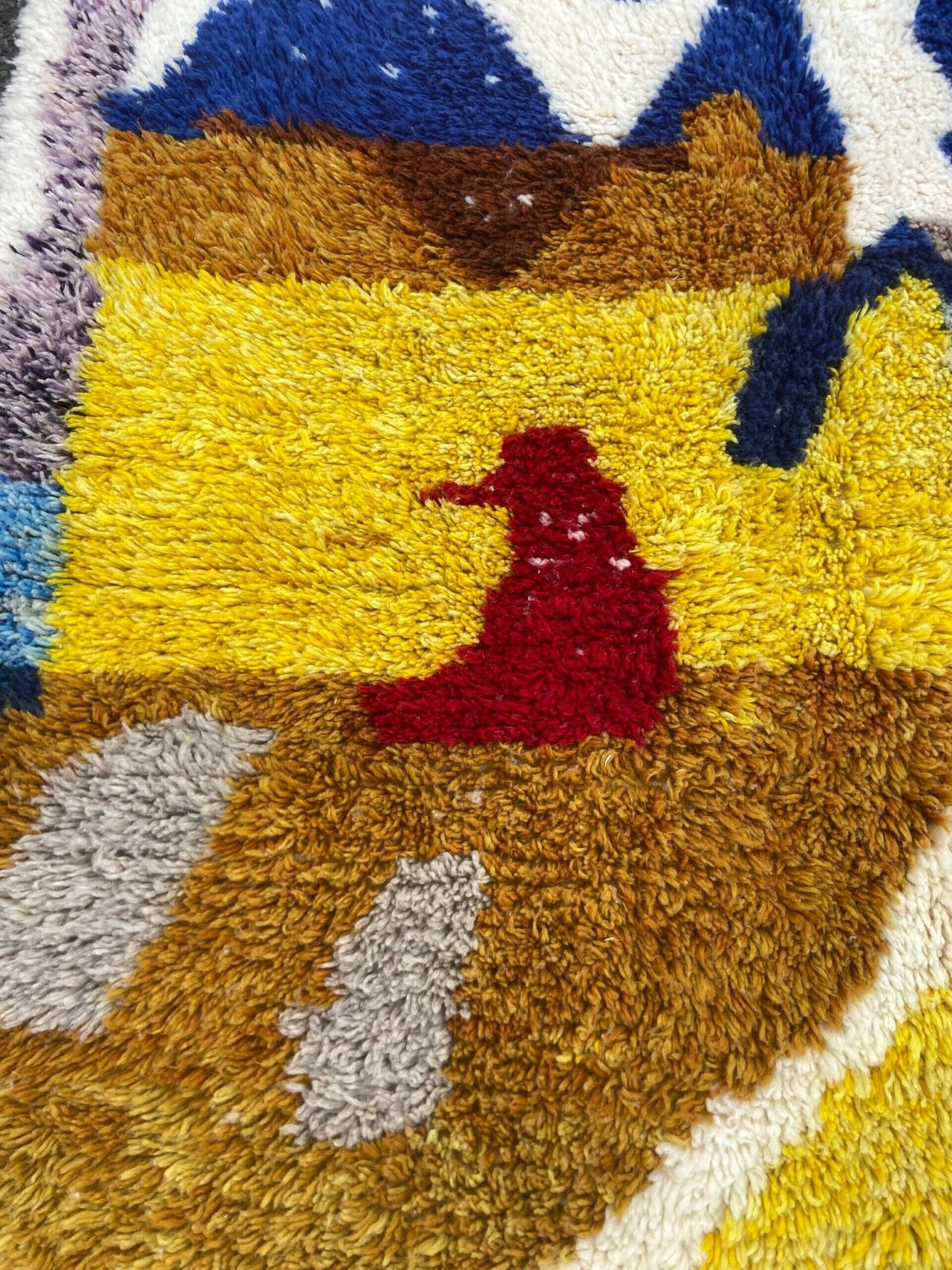 Close-up detail of a handwoven rug showcasing a textured pattern and colorful design.