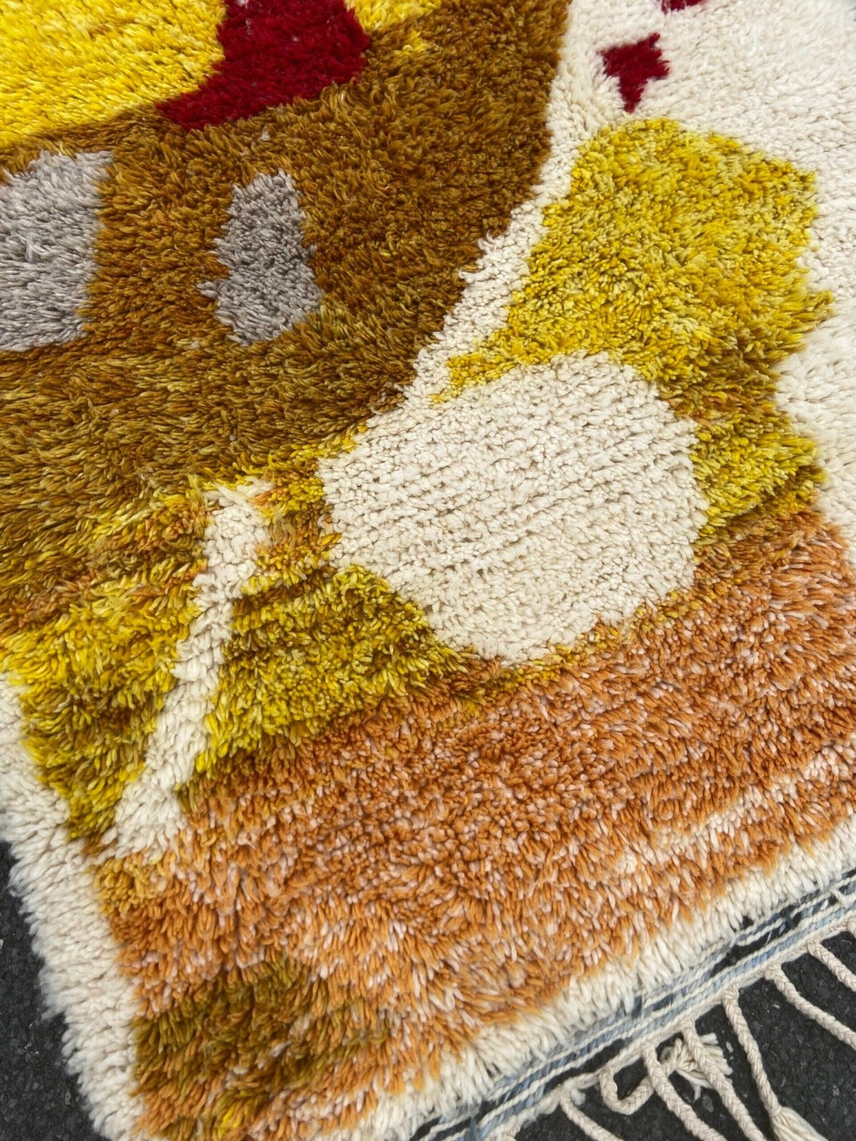 Close-up detail of a handwoven rug featuring geometric patterns and a soft texture.