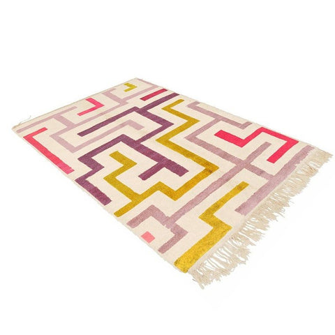 Lifestyle shot showcasing the purple, mustard, and pink Moroccan rug in a natural setting.
