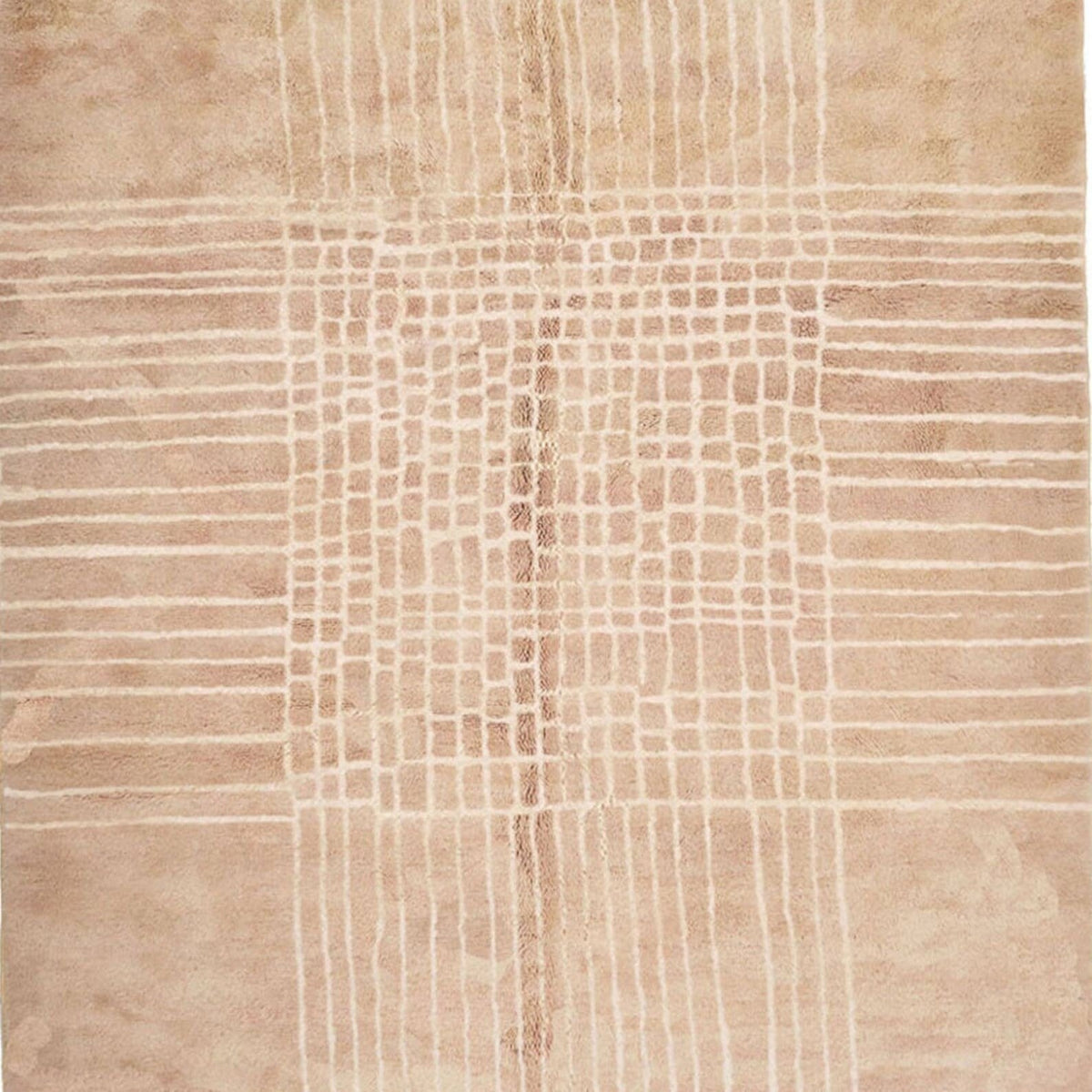 Detail close-up of a neutral Moroccan rug highlighting woven texture and fringe edges.