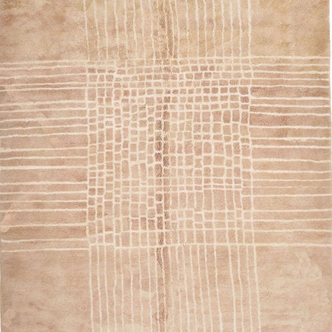 Detail close-up of a neutral Moroccan rug highlighting woven texture and fringe edges.