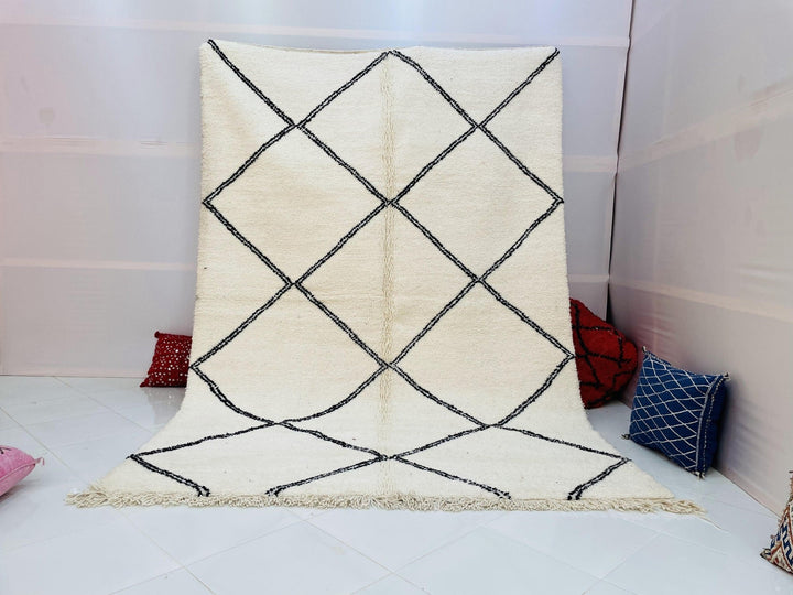 Lifestyle shot of a Moroccan rug featuring a diamond pattern in white and black.