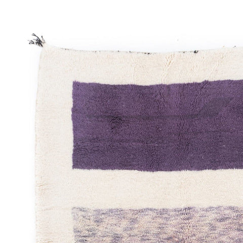 Detail view of the cream and burgundy color block Moroccan rug featuring geometric patterns.