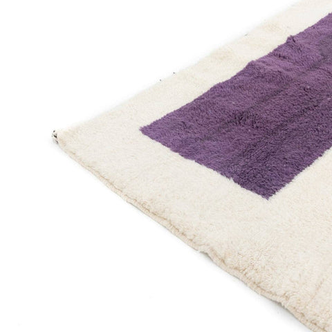 Detail shot of the cream and burgundy color block Moroccan rug emphasizing color contrast.