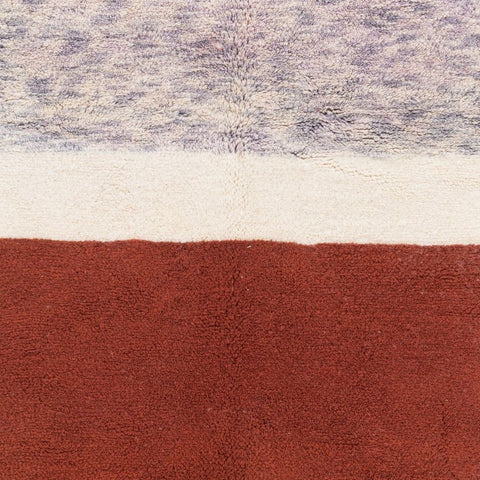 Close-up detail of the cream and burgundy color block Moroccan rug highlighting its textured surface.