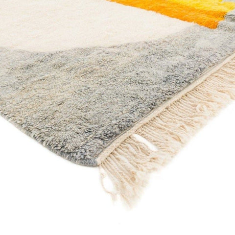 Close-up detail highlighting the layered colors of the gray and orange color block rug.