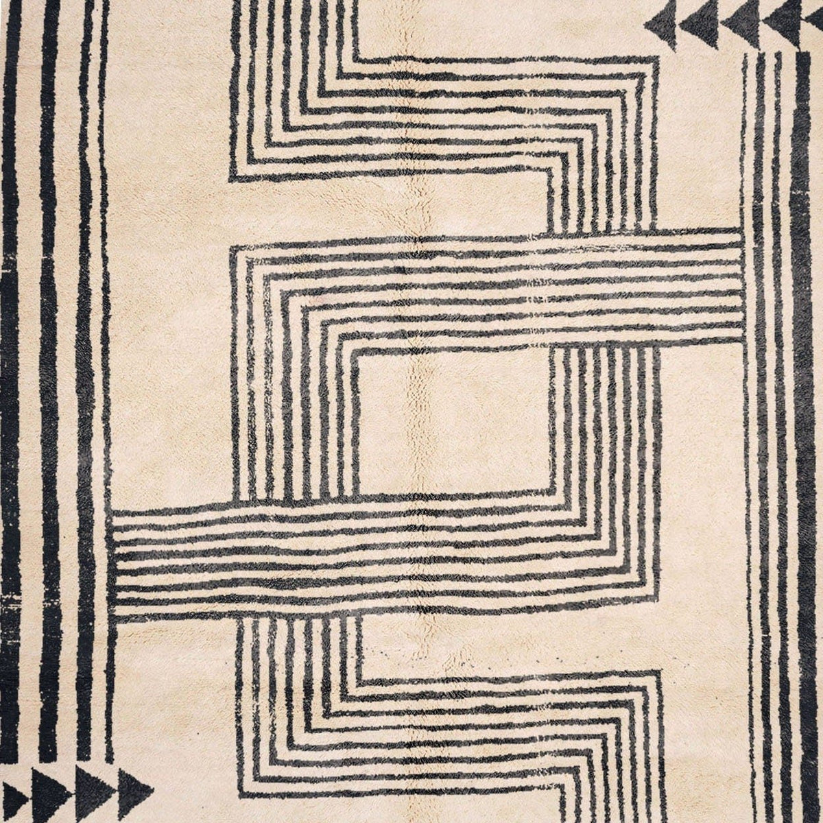 Side view of the cream and black Moroccan Beni Mrirt rug showcasing its geometric design.