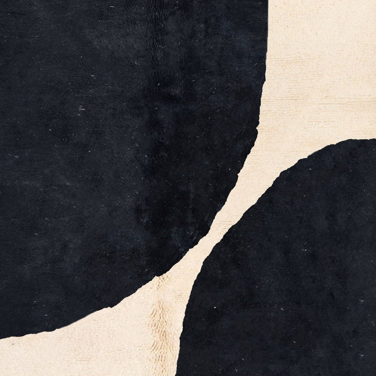 Side view of a black and white Moroccan Beni Ourain rug with a modern design and soft texture.
