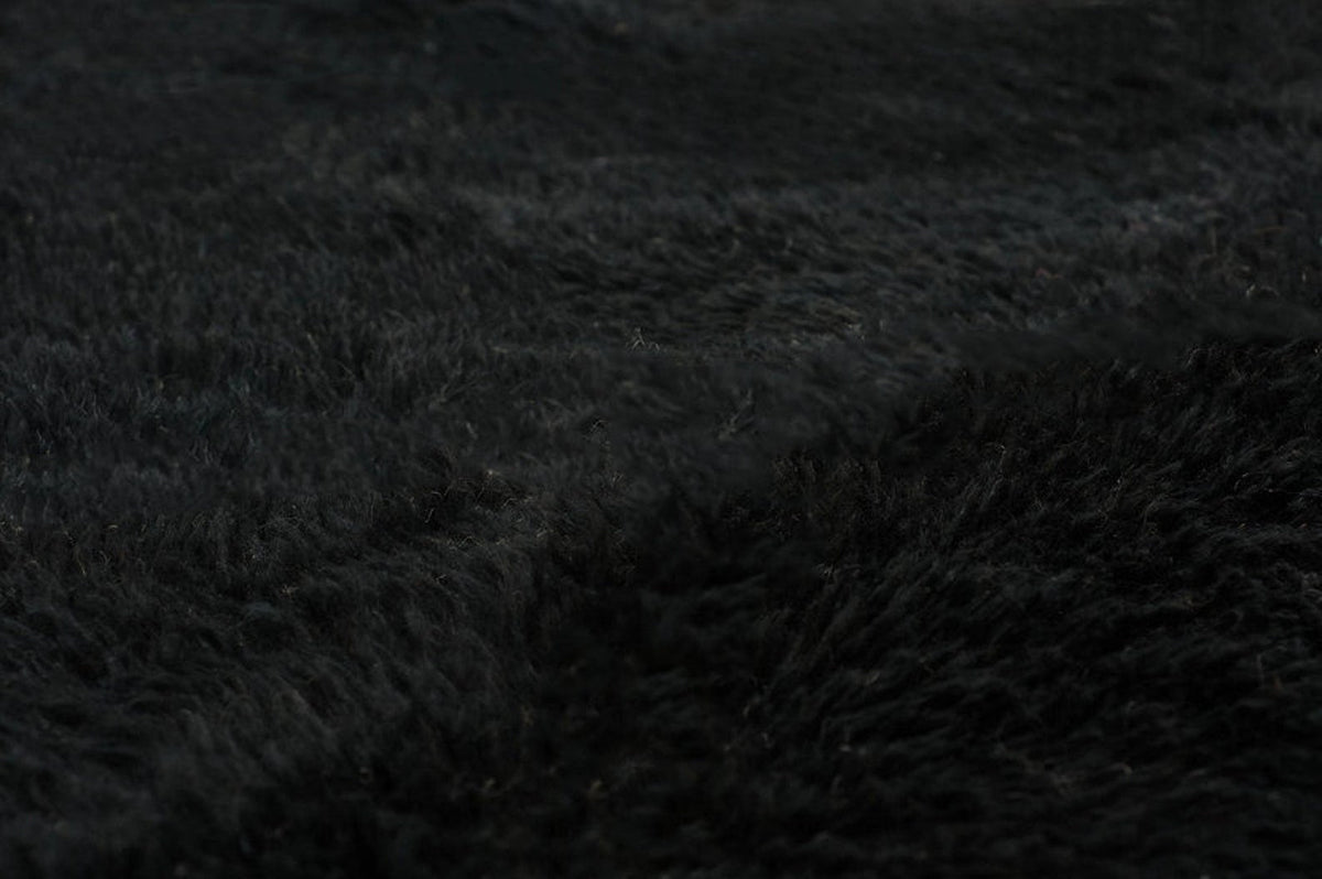 Detail view of a black and white Moroccan Beni Ourain rug highlighting its Berber design.