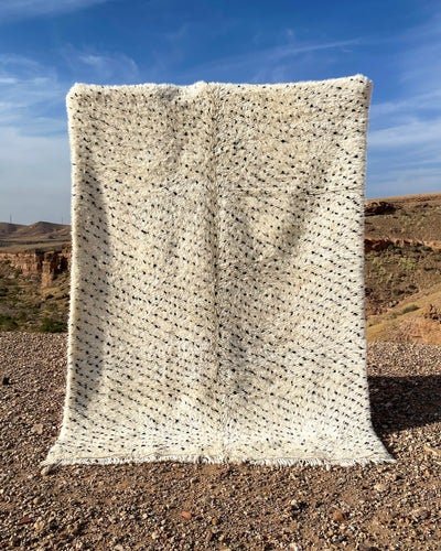 Front view of the gray and cream Moroccan Beni Ourain rug with a textured surface.