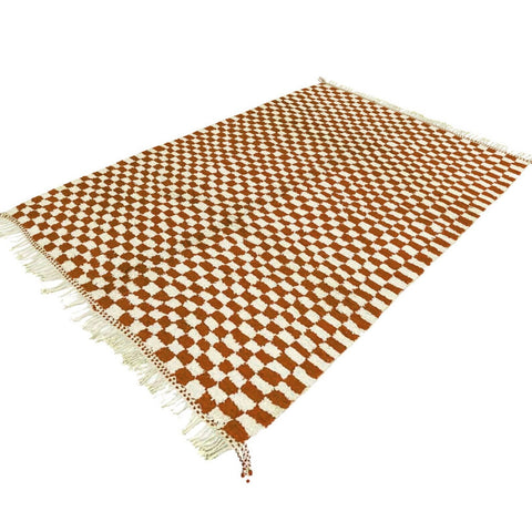 Side view of the beige checkered Moroccan rug highlighting its texture.