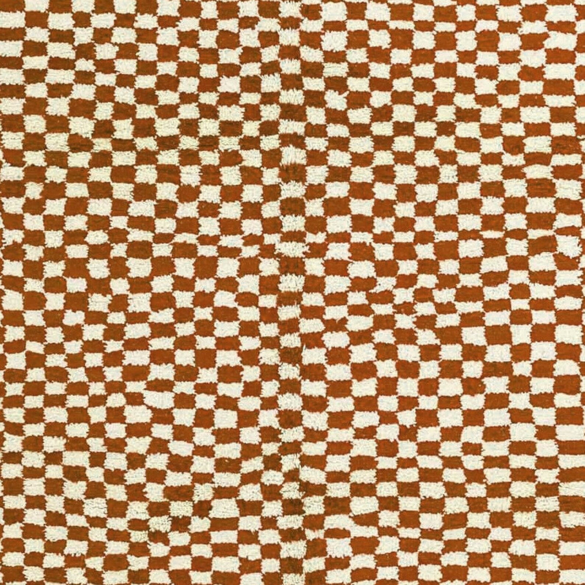 Close-up detail of the beige checkered pattern on the Moroccan rug.