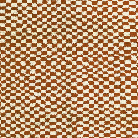 Close-up detail of the beige checkered pattern on the Moroccan rug.
