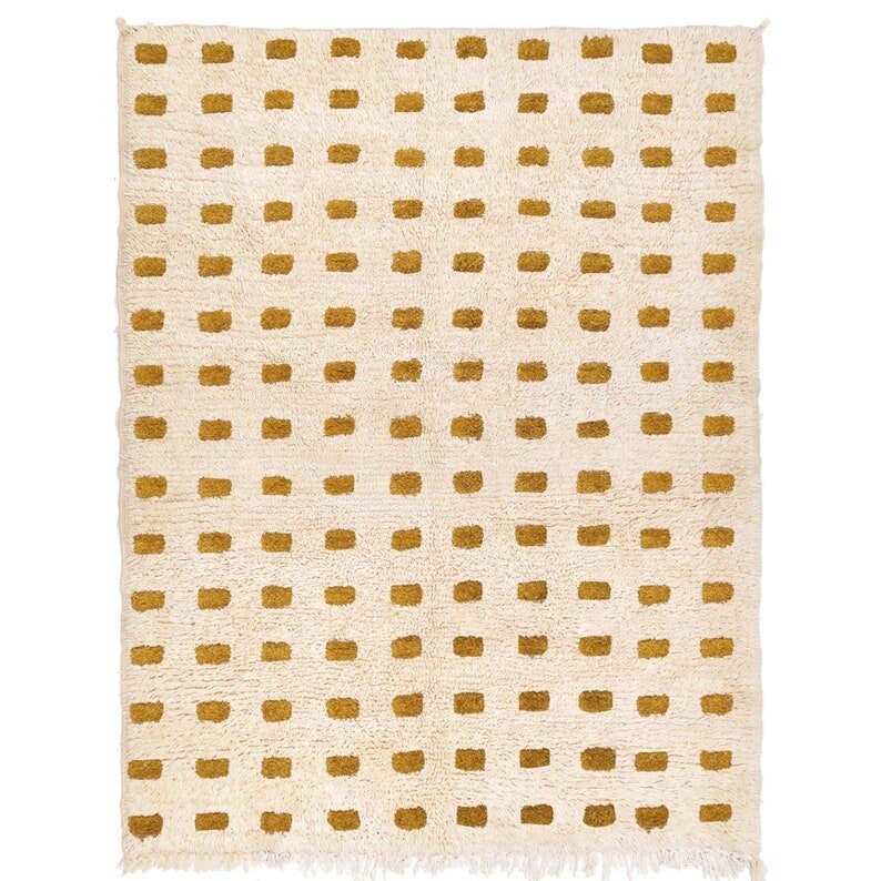 Detail close-up of the beige checkered pattern on a Moroccan rug with soft texture.