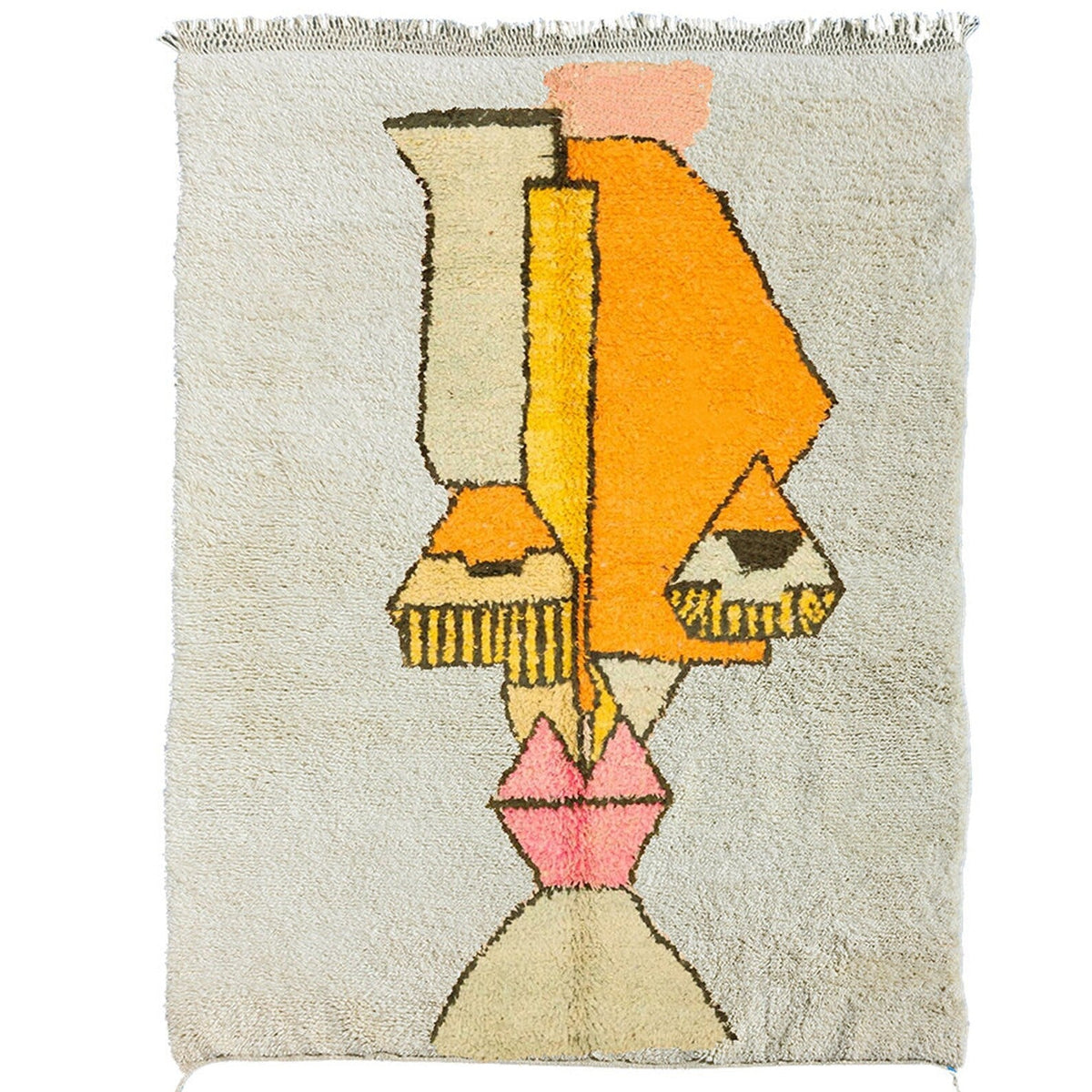 Detail close-up of the beige and orange geometric pattern on the Moroccan rug.