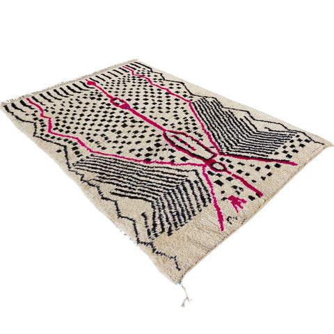 Detail close-up of the pink geometric patterns on the Berber Azilal rug.
