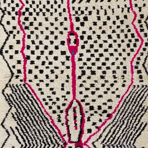 Detail close-up showcasing the geometric design in pink and black on the Azilal rug.