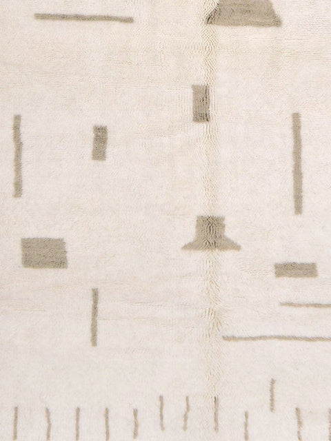 Front view of an off-white gray Moroccan rug with a geometric design and fringe edges.
