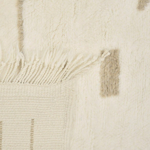 Front view of an off-white gray Moroccan rug highlighting geometric patterns and fringe edges.