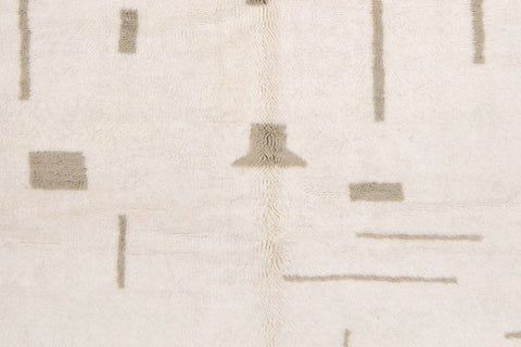 Front view of an off-white gray Moroccan rug showcasing geometric patterns and fringe edges.