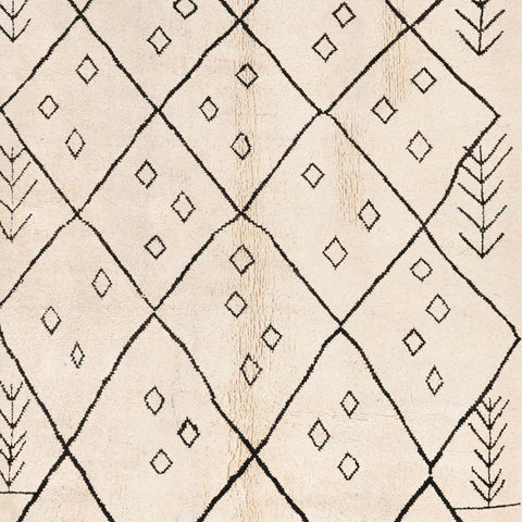 Close-up detail of the geometric designs on the cream dotted border Moroccan rug in beige and black.