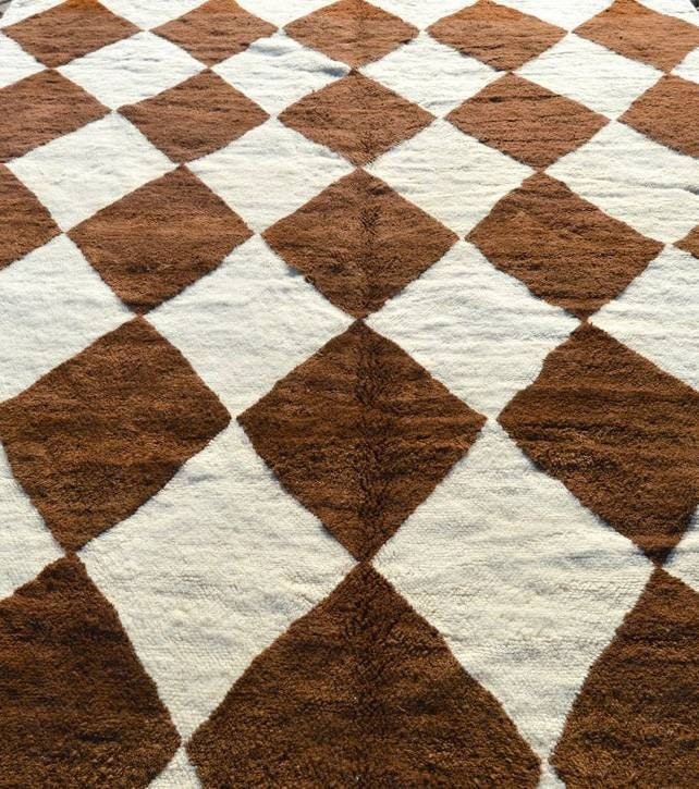 Full-length view of a geometric brown Moroccan rug highlighting its diamond pattern.