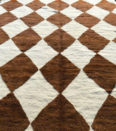 Full-length view of a geometric brown Moroccan rug highlighting its diamond pattern.