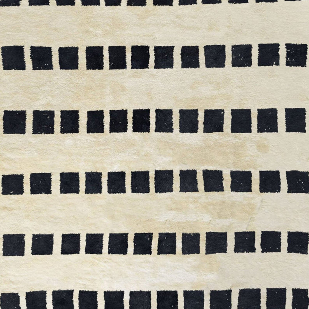 Side view of the black and white striped Moroccan rug showcasing its soft texture.
