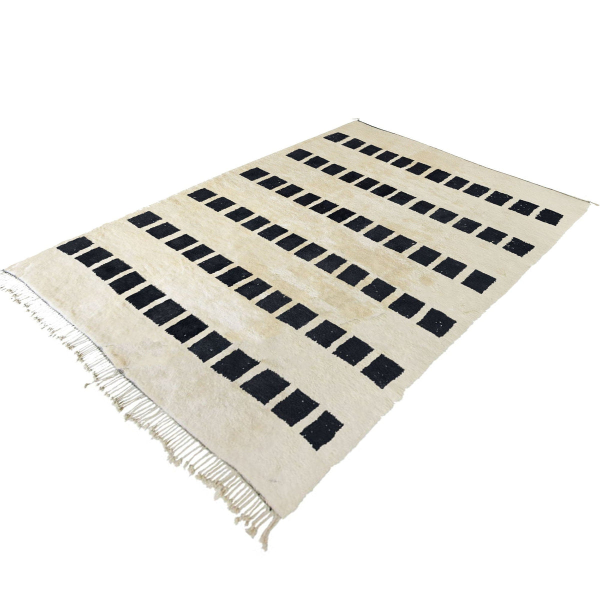Close-up detail of the woven texture on the black and white striped Moroccan rug.