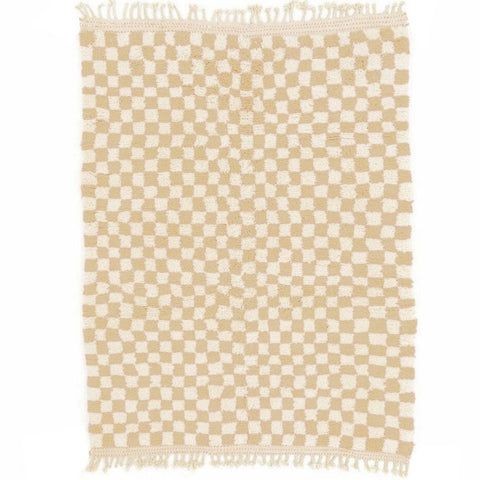 Detail close-up of the beige checkered pattern on a Moroccan rug against a white background.