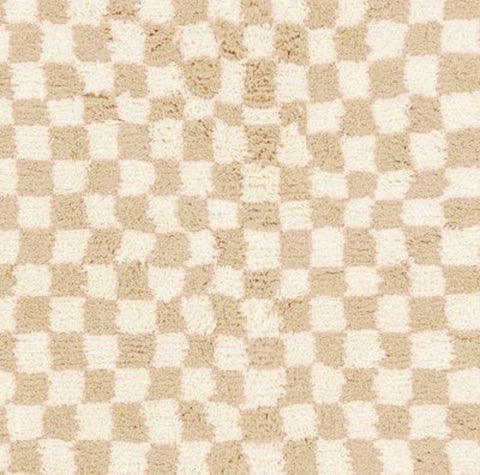Detail close-up showcasing the abstract design of the beige checkered Moroccan rug.