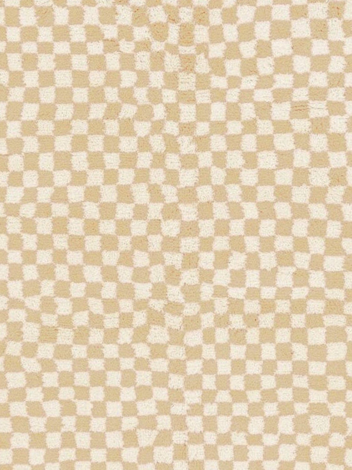 Detail close-up of the beige checkered Moroccan rug highlighting its abstract features.