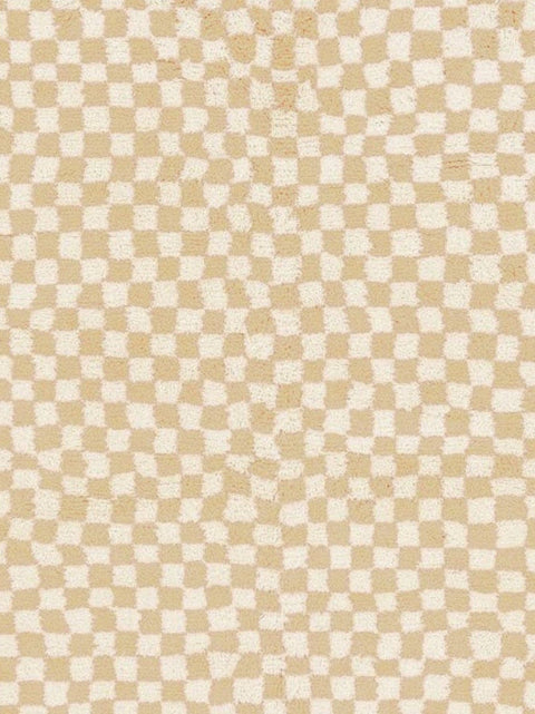 Detail close-up of the beige checkered Moroccan rug highlighting its abstract features.
