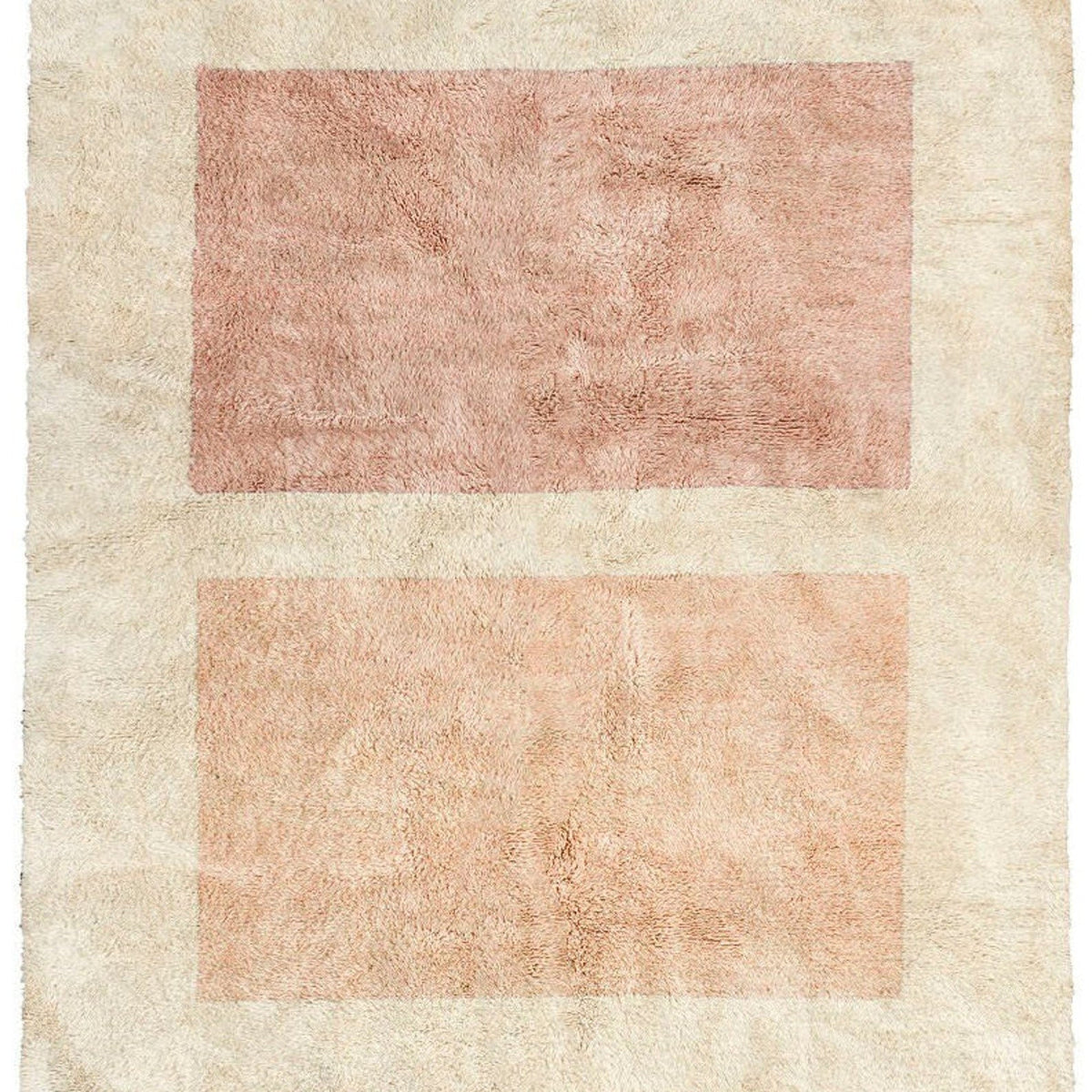 Detail close-up of a beige and pink geometric abstract rug on a white background