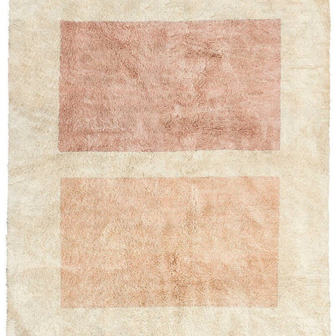 Detail close-up of a beige and pink geometric abstract rug on a white background