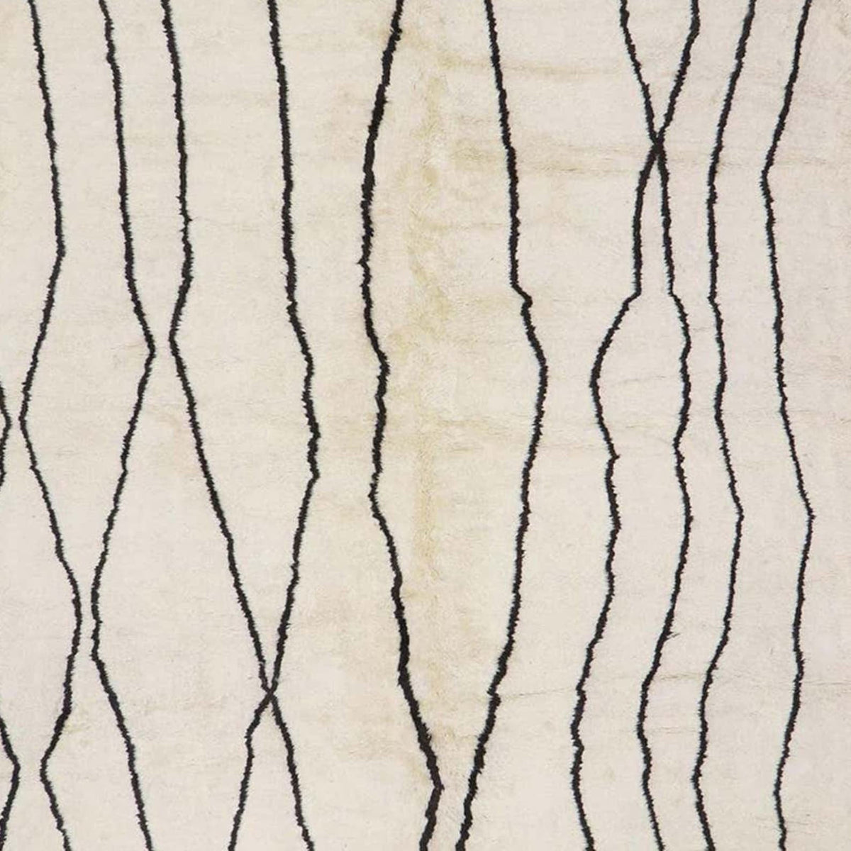 Front view of the off-white Beni Ourain rug showcasing a geometric design and fringe edges.