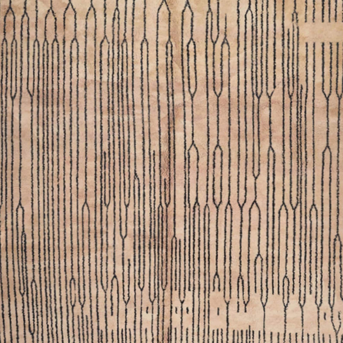 Detail close-up of the black and white Moroccan rug featuring fringe edges and Berber design.
