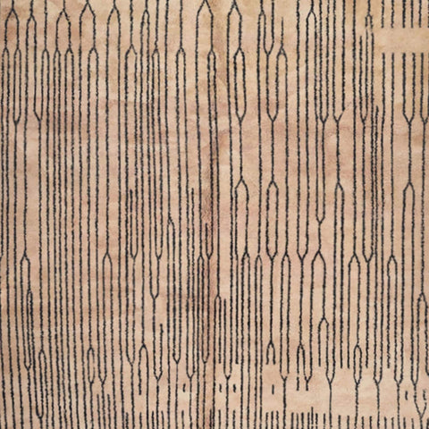 Detail close-up of the black and white Moroccan rug featuring fringe edges and Berber design.