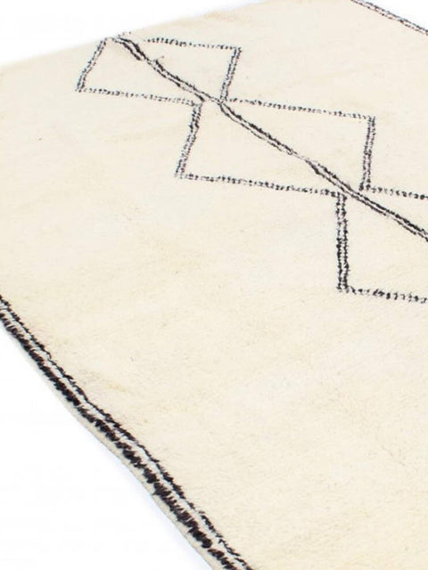Close-up detail of the black and white Moroccan rug with a focus on its geometric features.