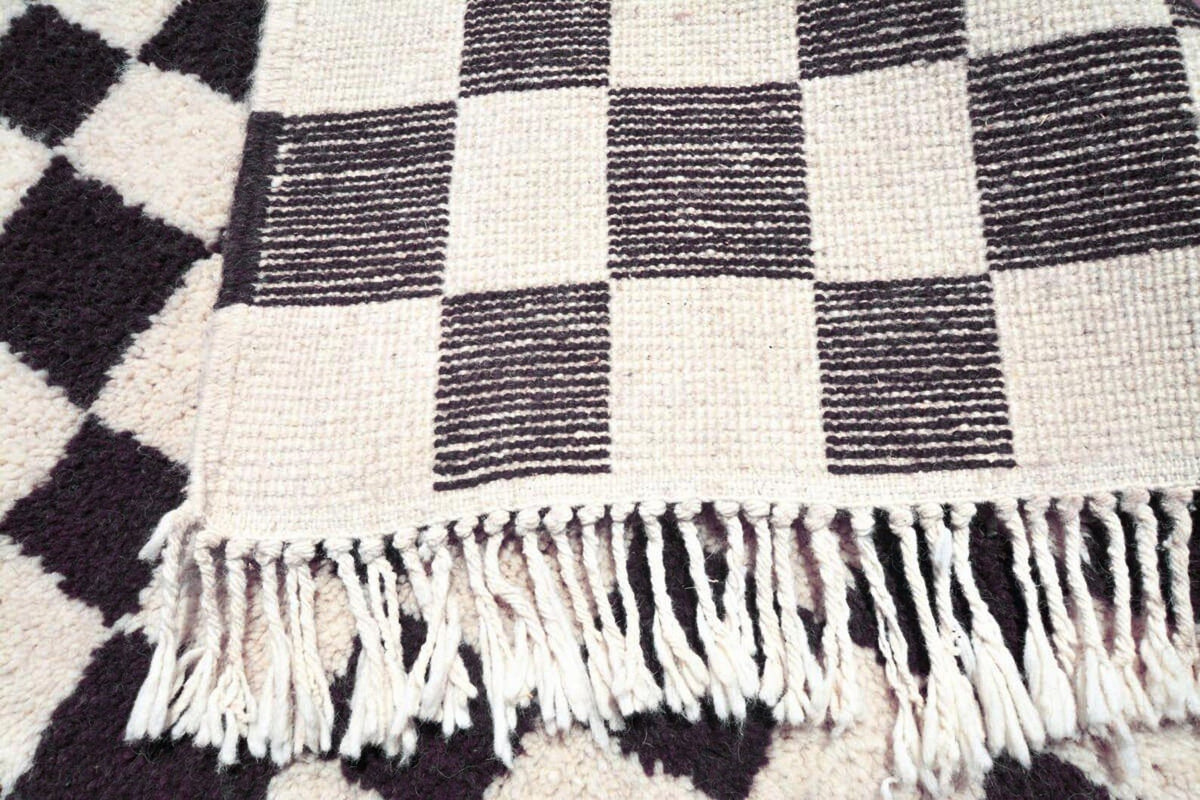 Detail close-up of the checkered pattern on the Moroccan rug.