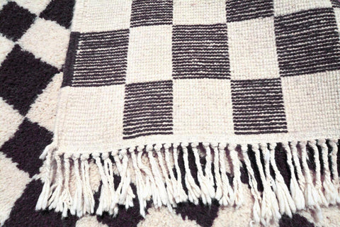 Detail close-up of the checkered pattern on the Moroccan rug.