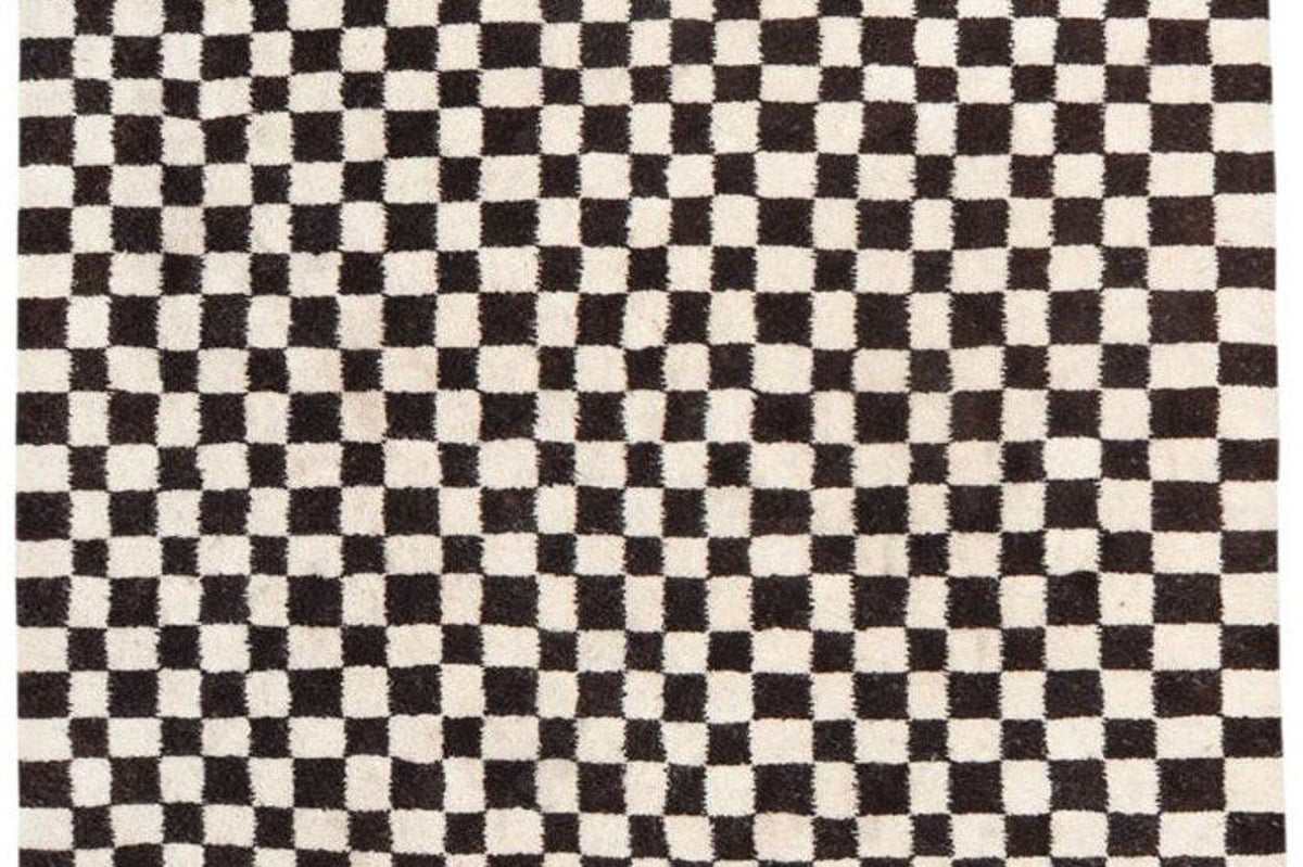 Detail close-up showcasing the black and white checkered design of the rug.